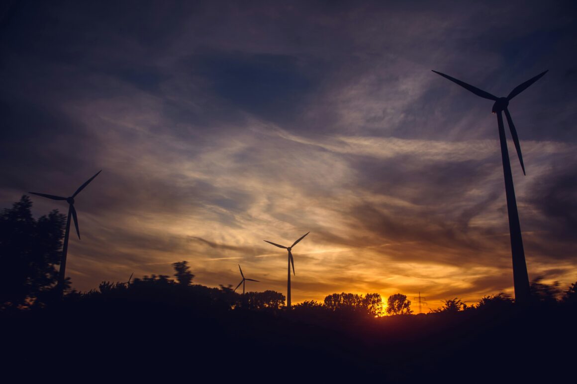 Renewable energy - Wind turnbines in front of a sunset.